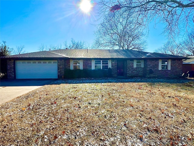 ranch-style home with a garage and a front lawn