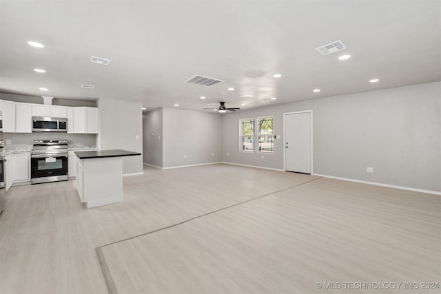 kitchen featuring appliances with stainless steel finishes, a kitchen island, ceiling fan, white cabinets, and light hardwood / wood-style flooring