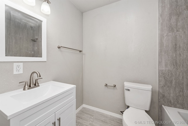 full bathroom featuring vanity, toilet, plus walk in shower, and hardwood / wood-style floors