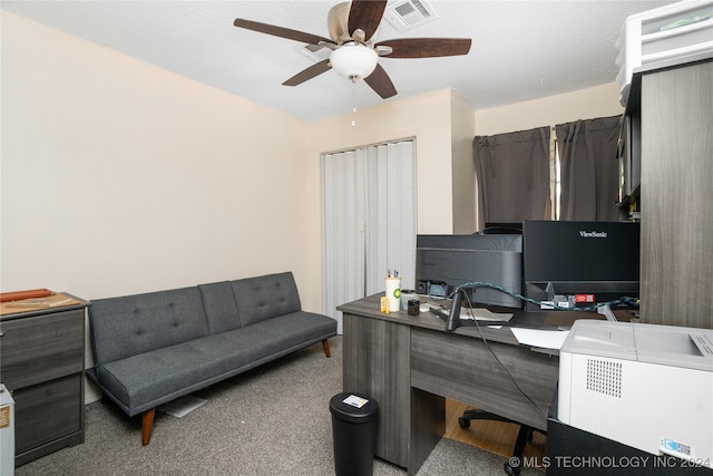 home office with ceiling fan, carpet, and a textured ceiling