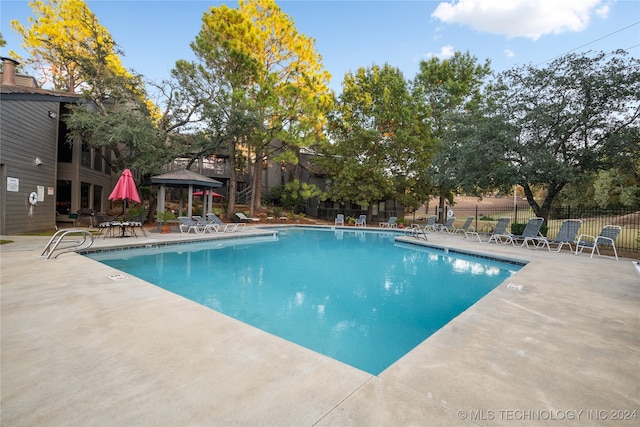 view of swimming pool with a patio and a gazebo