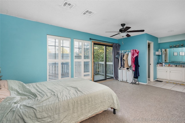 bedroom with ceiling fan, access to outside, a textured ceiling, and ensuite bathroom