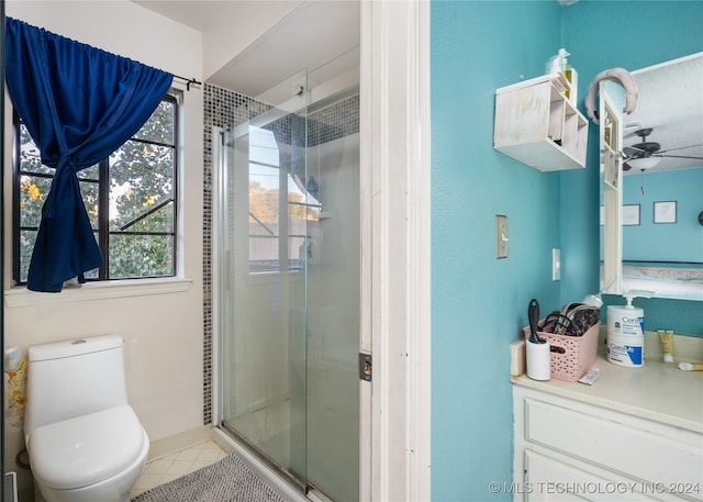 bathroom featuring toilet, tile patterned floors, walk in shower, and ceiling fan