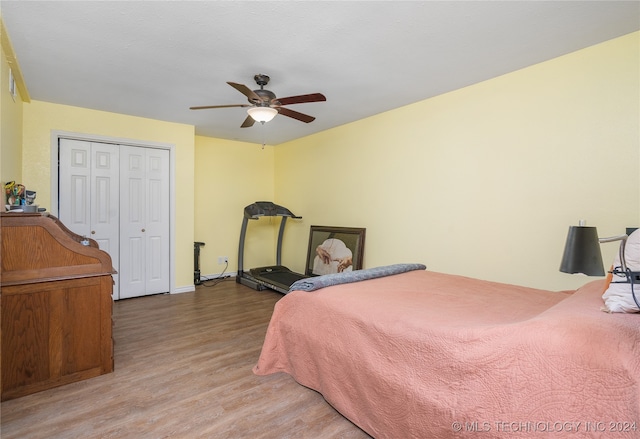 bedroom featuring hardwood / wood-style floors, a closet, and ceiling fan