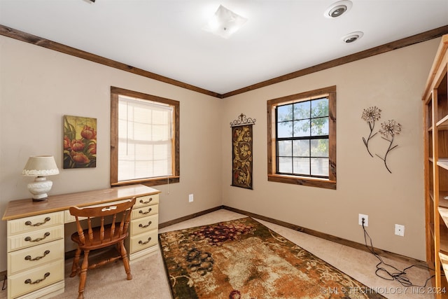 office area with built in desk, a healthy amount of sunlight, and ornamental molding