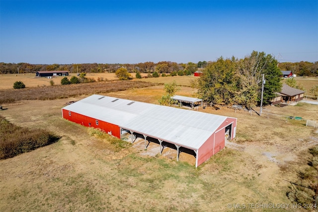 birds eye view of property with a rural view