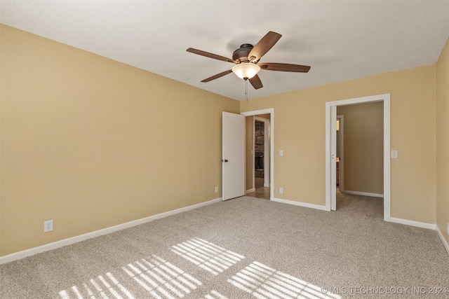 unfurnished bedroom featuring carpet, a closet, and ceiling fan