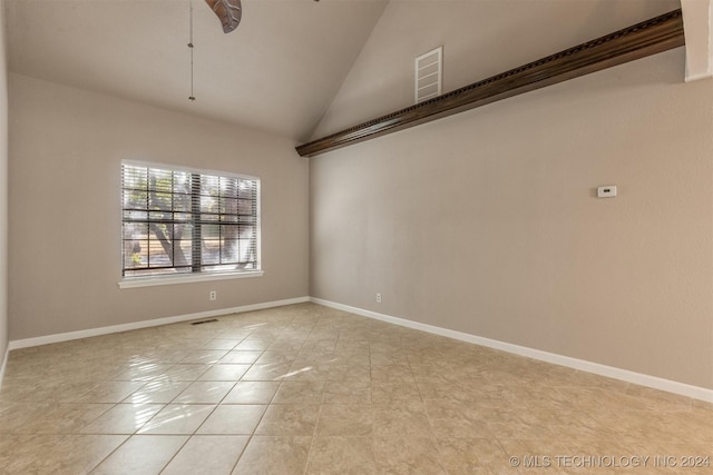 unfurnished room with vaulted ceiling, light tile patterned floors, and ceiling fan