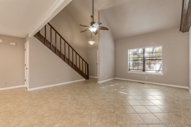 unfurnished living room with vaulted ceiling, ceiling fan, and light tile patterned floors