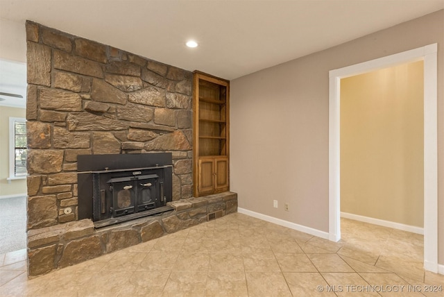 unfurnished living room featuring built in features and light tile patterned floors