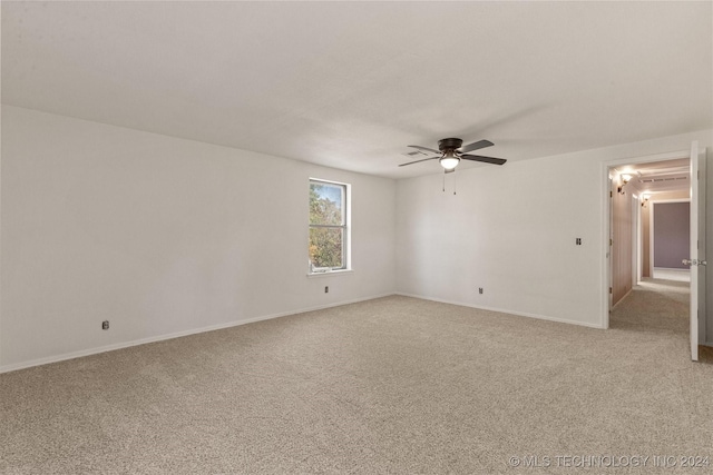 empty room featuring ceiling fan and light colored carpet