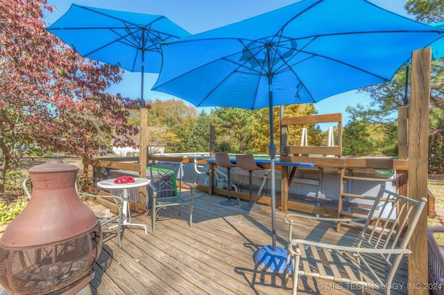 wooden terrace featuring exterior bar