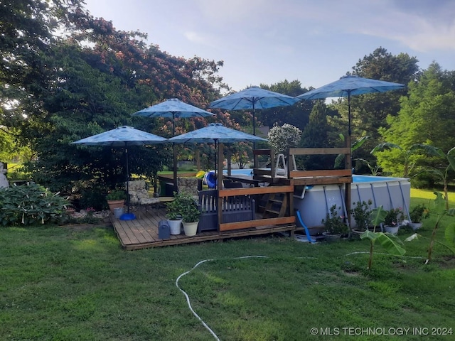 view of yard with a pool side deck