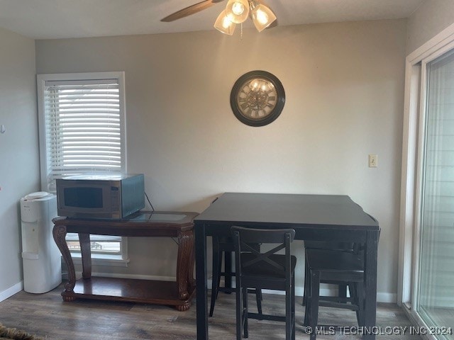 dining area featuring ceiling fan and dark hardwood / wood-style floors