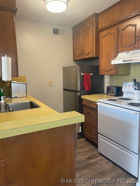 kitchen featuring sink, dark hardwood / wood-style floors, stainless steel fridge, premium range hood, and electric stove