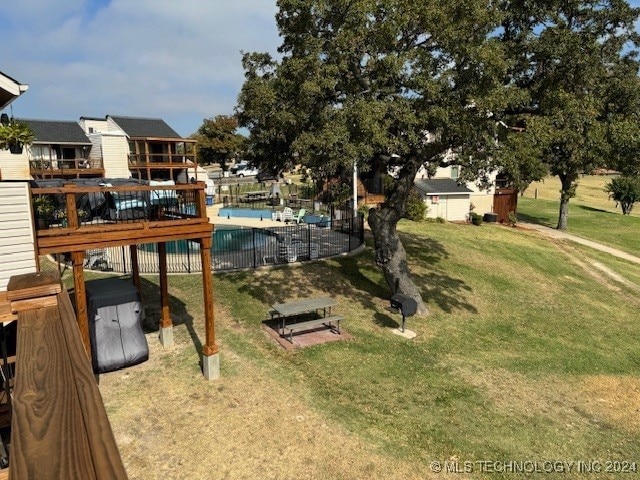 view of yard with a pool side deck