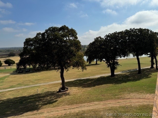 view of property's community featuring a lawn and a rural view