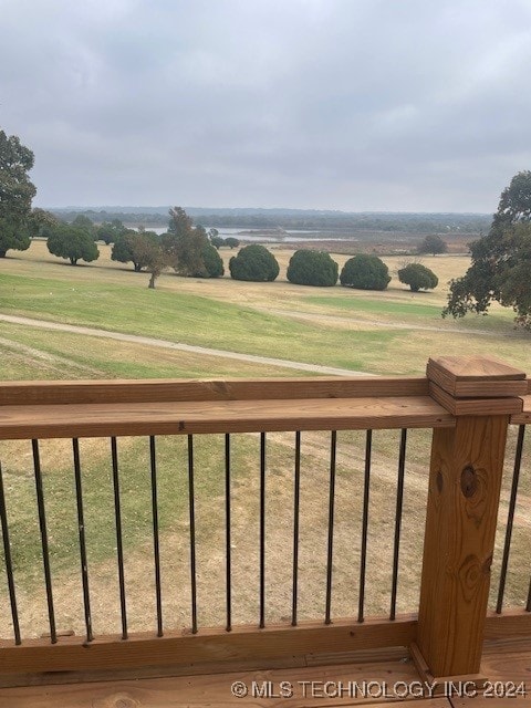 view of yard with a rural view and a balcony