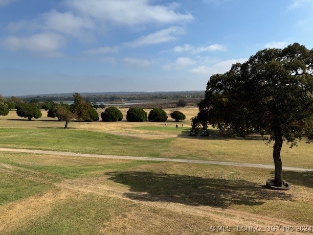 view of home's community featuring a rural view and a yard