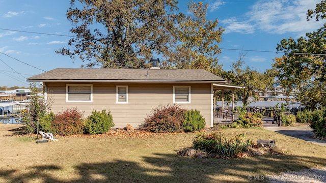 view of side of property with a yard