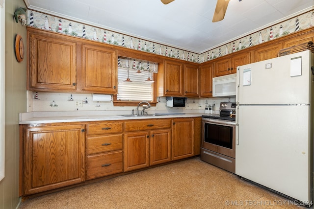 kitchen featuring white appliances, sink, and ceiling fan