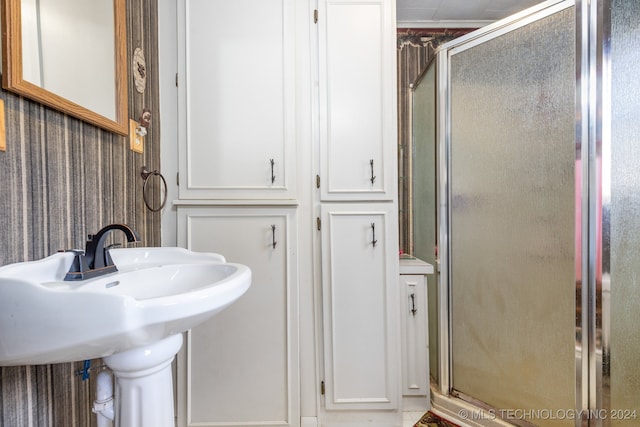 bathroom featuring a shower with shower door