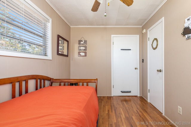 unfurnished bedroom with ornamental molding, wood-type flooring, and ceiling fan