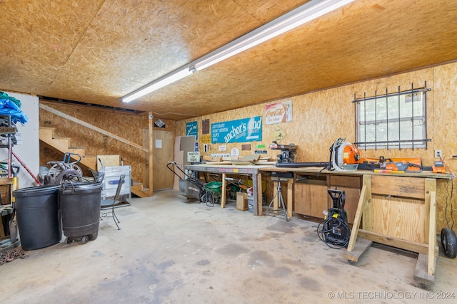 misc room with a workshop area and concrete floors