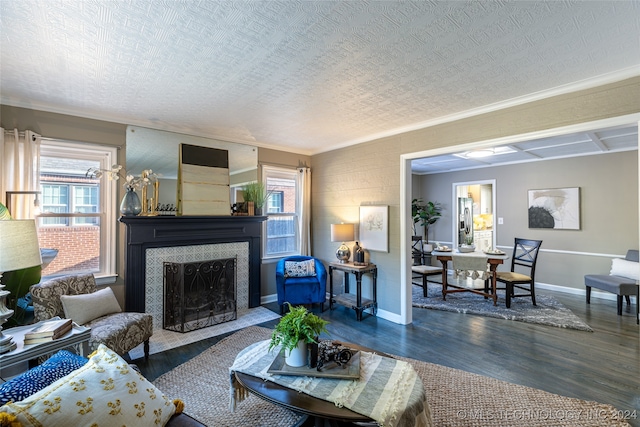 living room featuring a textured ceiling, dark wood-type flooring, and a wealth of natural light