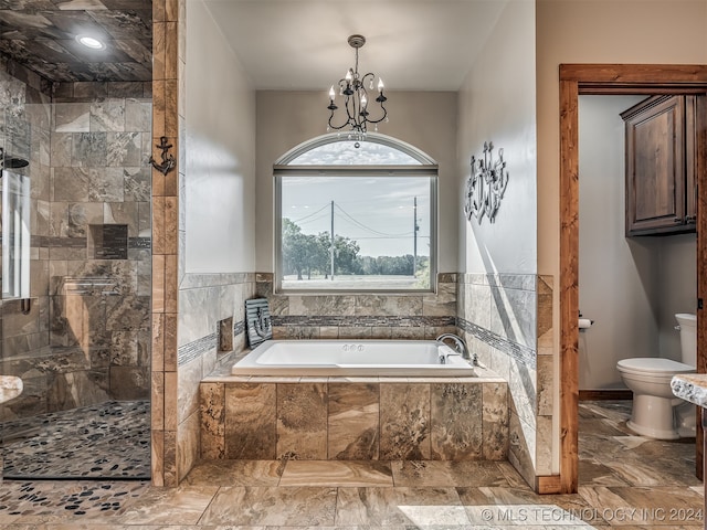 bathroom featuring toilet, a notable chandelier, and independent shower and bath