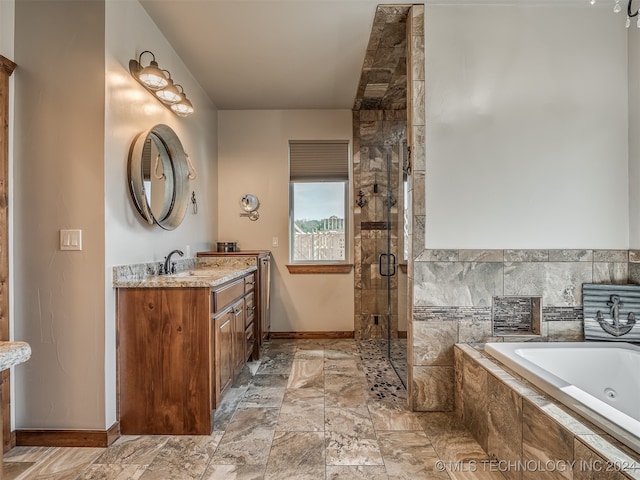 bathroom with vanity and separate shower and tub