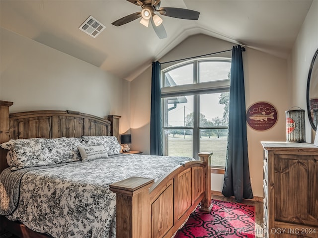 bedroom featuring hardwood / wood-style floors, ceiling fan, and vaulted ceiling