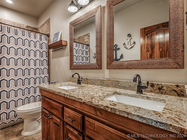 bathroom featuring vanity, toilet, and a shower with curtain