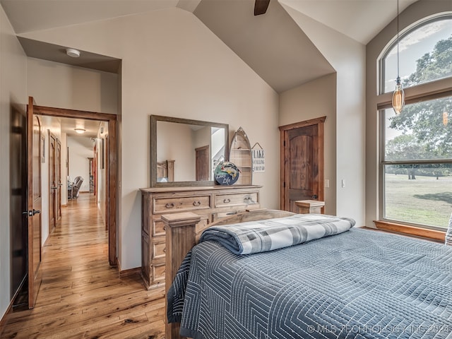 bedroom featuring high vaulted ceiling, light wood-type flooring, and ceiling fan