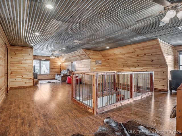 bonus room with wood ceiling, lofted ceiling, ceiling fan, dark hardwood / wood-style flooring, and wood walls