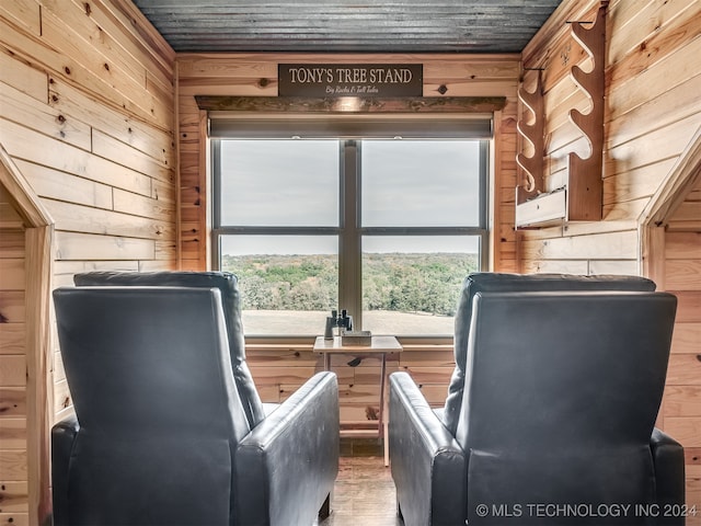 unfurnished room with hardwood / wood-style floors, wooden walls, wood ceiling, and a healthy amount of sunlight