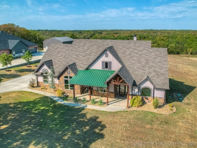 rear view of property featuring a yard