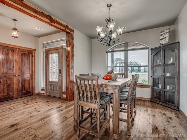 dining area featuring a chandelier and light wood-type flooring