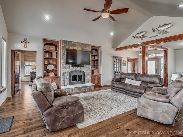 living room with vaulted ceiling, plenty of natural light, a fireplace, and hardwood / wood-style floors