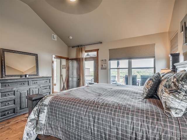 bedroom with hardwood / wood-style floors, high vaulted ceiling, and ceiling fan