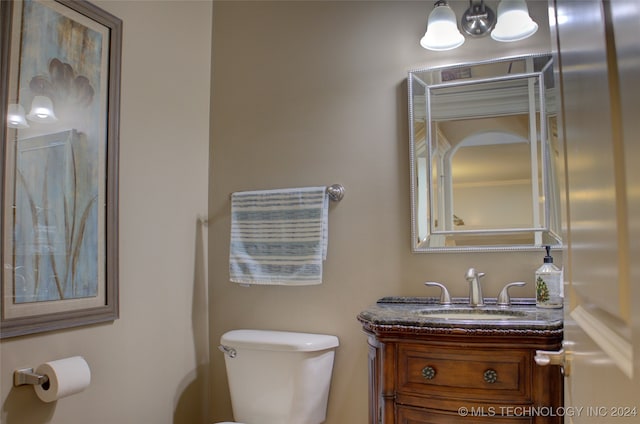 bathroom with toilet and vanity