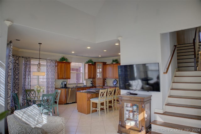 tiled living room with a high ceiling, sink, and crown molding