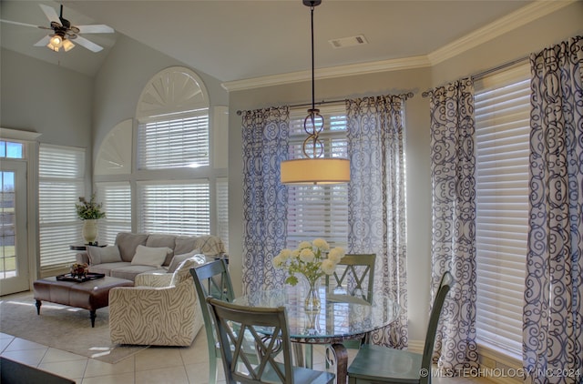 dining area with lofted ceiling, light tile patterned floors, ceiling fan, and crown molding