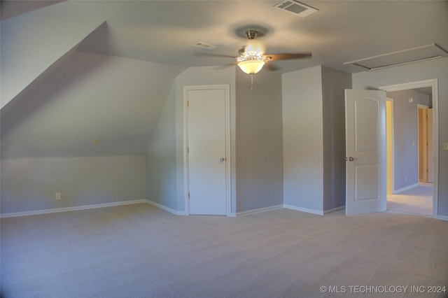 additional living space with ceiling fan, light carpet, and vaulted ceiling