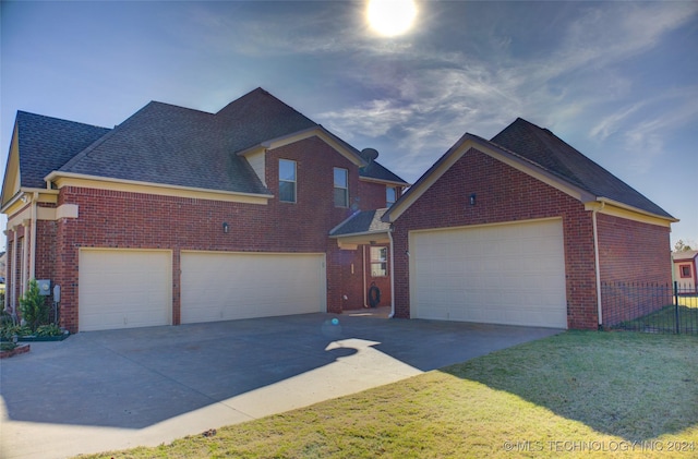 view of front of property with a front yard and a garage