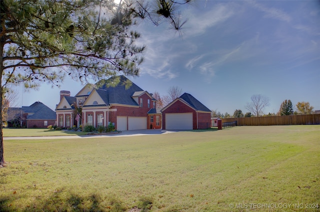 view of front of home featuring a front lawn and a garage