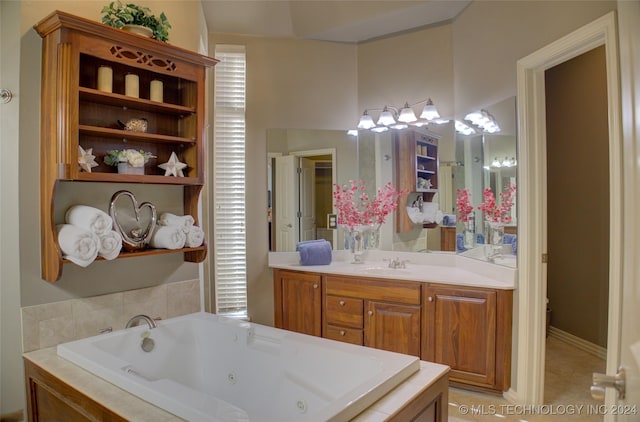 bathroom with tiled bath, tile patterned flooring, and vanity