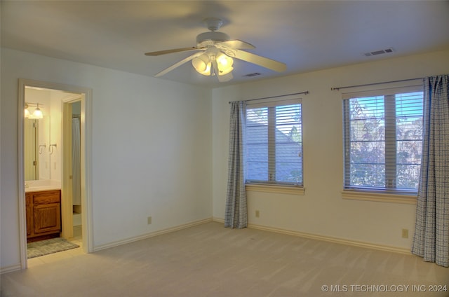 spare room featuring ceiling fan and light colored carpet