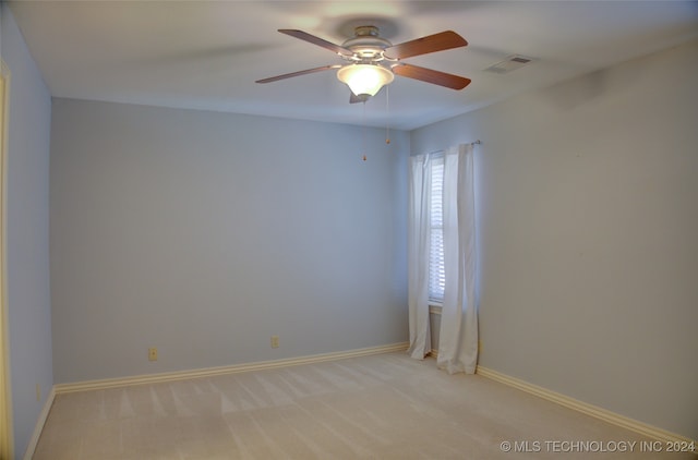 empty room with ceiling fan and light colored carpet