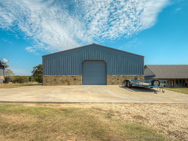 view of outdoor structure featuring a yard and a garage